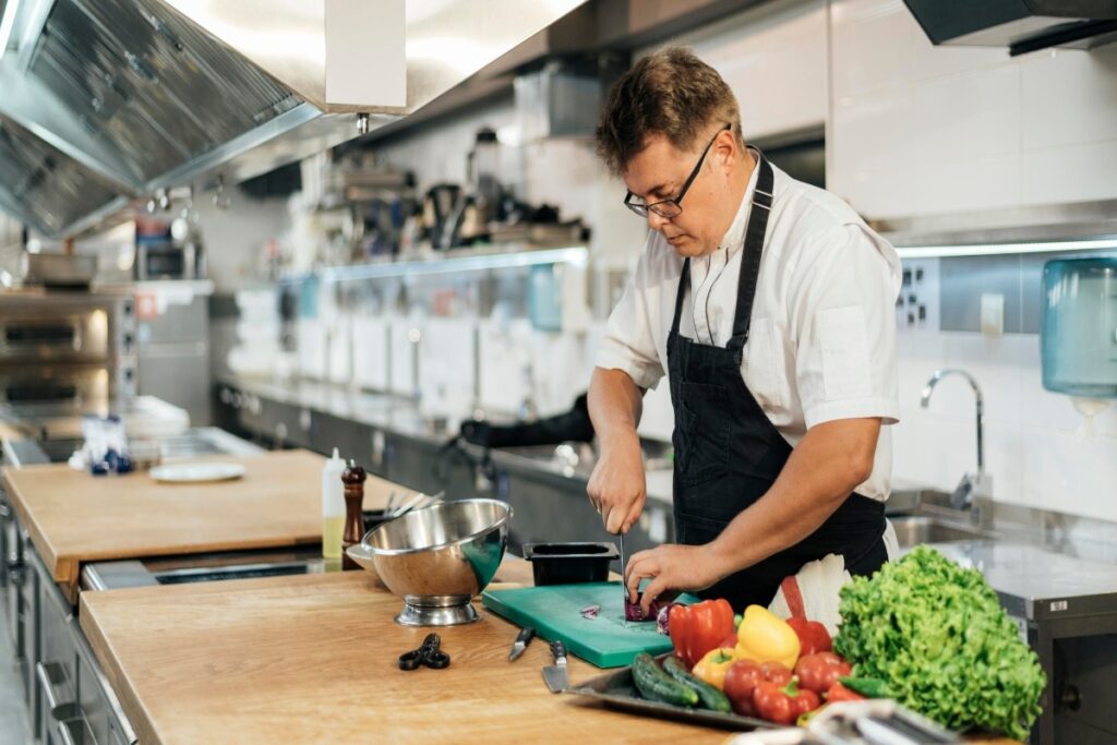 A chef in a kitchen with hoods.